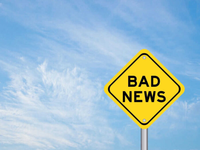 shutterstock_2265927471.jpg Yellow sign reads bad news in sky