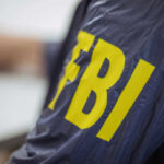 FBI Stormed His Home — What They Found Stuns DC Person wearing FBI jacket, letters in yellow