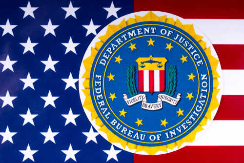 shutterstock_1055600861.jpg FBI seal overlaid on an American flag background