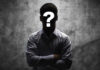 Silhouetted person with a question mark on their face