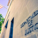 DOJ Drops Bombshell: Notorious Voter Tech Firm Busted Department of Justice building with American flag.