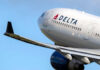 Delta airplane in flight with blue sky background