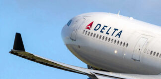 Delta airplane in flight with blue sky background