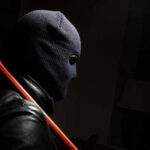 Daring Heist: Priceless Crown Jewels STOLEN! Person in ski mask holding a crowbar.