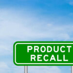 RECALL: Exploding Cookers Burn Customers Green sign with product recall text and sky background