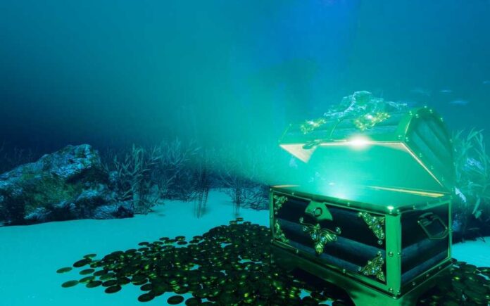 shutterstock_2358559701.jpg An open treasure chest surrounded by coins on the ocean floor