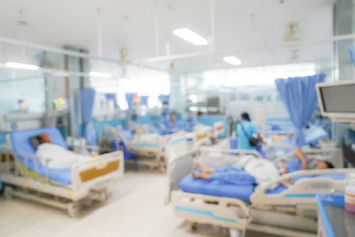 shutterstock_2376696323.jpg Blurred hospital room with multiple patients and nurses