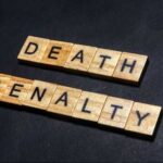 Death Penalty Execution Spree Breaks All Records Wooden letter tiles spelling DEATH PENALTY on a dark background