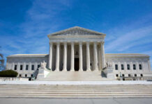 U.S. Supreme Court building under clear blue sky