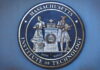 Bronze seal of the Massachusetts Institute of Technology featuring two figures and the year 1861