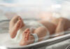280 Children DEAD From Mutated Flu Newborn baby in hospital bassinet with ID band.