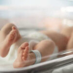 280 Children DEAD From Mutated Flu Newborn baby in hospital bassinet with ID band.