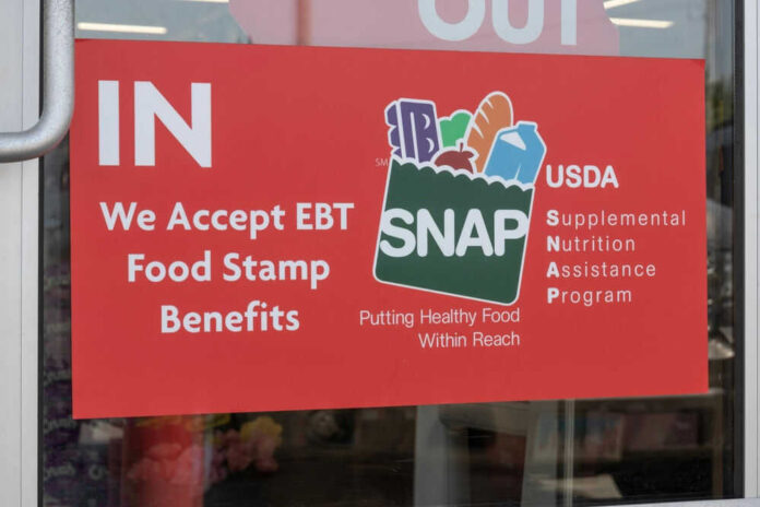 Red sign accepting EBT food stamp benefits SNAP