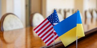 American and Ukrainian flags displayed on a conference table