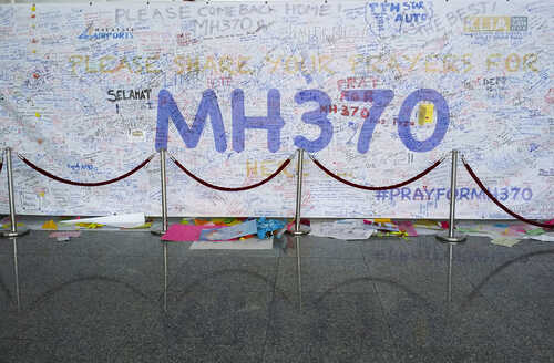 shutterstock_182049074 (1).jpg A large wall covered in messages and prayers for MH370