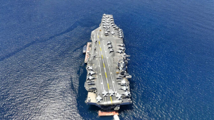 Aircraft carrier on open sea with parked planes