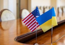 American and Ukrainian flags displayed on a conference table