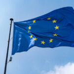 European Union flag waving against a blue sky