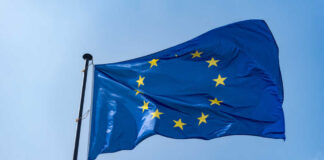 European Union flag waving against a blue sky
