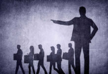 Shadows of laid-off workers walking, large figure pointing.