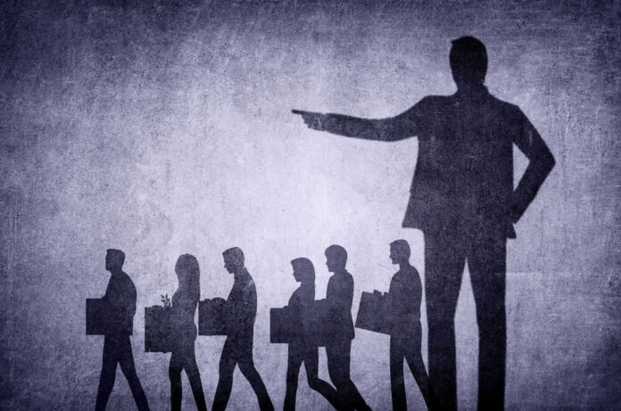shutterstock_2254036017.jpg Shadows of laid-off workers walking, large figure pointing.