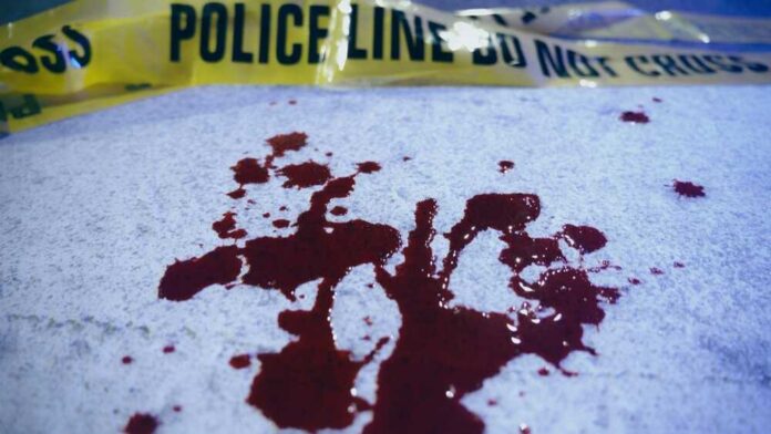 Blood stains on a surface with police caution tape in the background