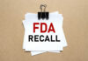Dangerous Contamination Sparks FDA Dog Treat Recall A notice labeled 'FDA RECALL' clipped to white papers on a brown background