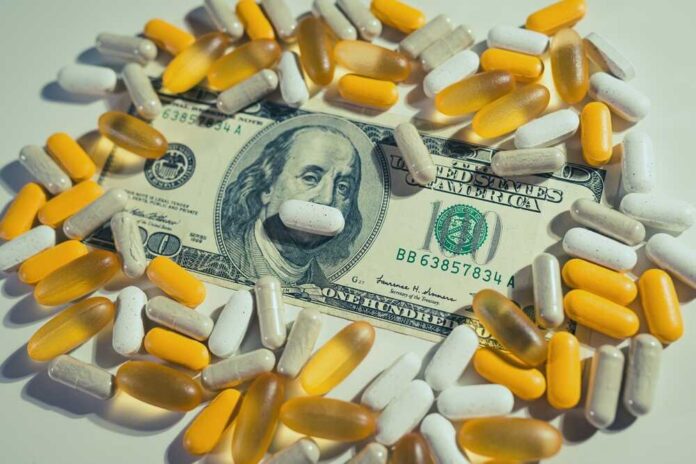 A one hundred dollar bill surrounded by various capsules and pills