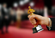Hand holding an Oscar award