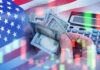 USA flag calculator and hands holding dollars overlapping