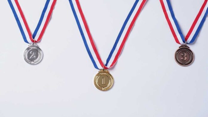 shutterstock_2489377729.jpg Three medals representing first, second, and third place
