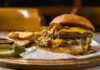 42g Breakfast Burger Hits Drive-Thru A double cheeseburger with melted cheese and pickles served with potato wedges