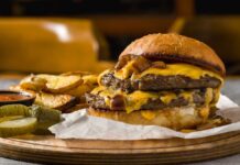 42g Breakfast Burger Hits Drive-Thru A double cheeseburger with melted cheese and pickles served with potato wedges