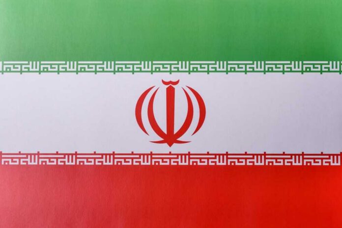 shutterstock_2633047733.jpg The flag of Iran featuring green, white, and red horizontal stripes with a central emblem