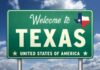 Welcome sign for Texas with the state flag