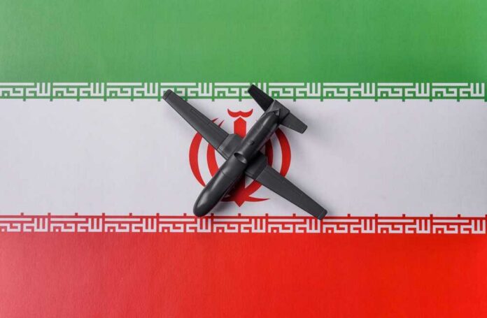 shutterstock_2732412695.jpg A model airplane placed on the Iranian flag