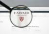 Epstein Documents Destroy Harvard Power Player Magnifying glass focusing on Harvard University logo online
