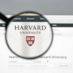 Magnifying glass focusing on Harvard University logo online