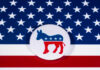 Democratic Party donkey logo on American flag background.