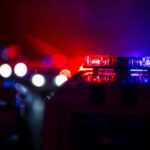 Shocking Ambush: Cop Targeted Police car lights shining in the dark.