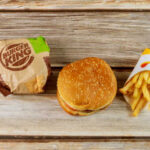Whopper Shake-Up: Burger King Responds to Customers Burger King hamburger and fries on a wooden surface