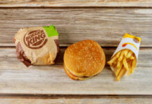 Burger King hamburger and fries on a wooden surface