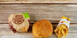 Burger King hamburger and fries on a wooden surface