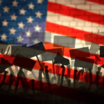 3,000 Rallies Erupt — America’s Breaking Point? Silhouetted crowd holding protest signs in front of an American flag