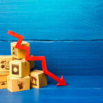 STUNNING Collapse: 153 Recalls In One Year Stack of cardboard boxes with a red downward arrow indicating decline