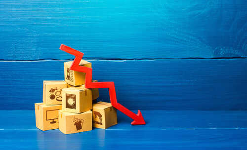 shutterstock_1863967129 (1).jpg Stack of cardboard boxes with a red downward arrow indicating decline