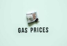 A bundle of cash next to the words 'GAS PRICES' on a light green background