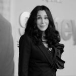Cher’s Son’s SHOCKING Prep School Rampage Cher with dark hair smiling.