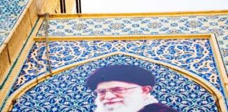 Mural of Ali Khamenei with decorative background and text