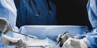 Surgeons performing a procedure in an operating room